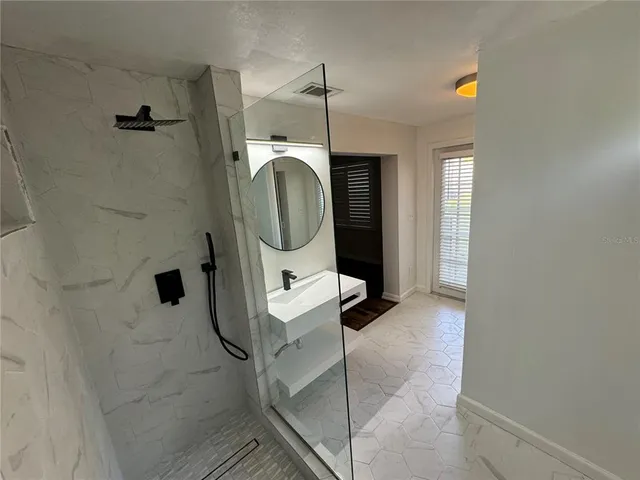 a bathroom with a sink and mirror