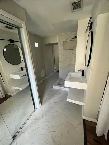 a bathroom with a sink toilet and shower