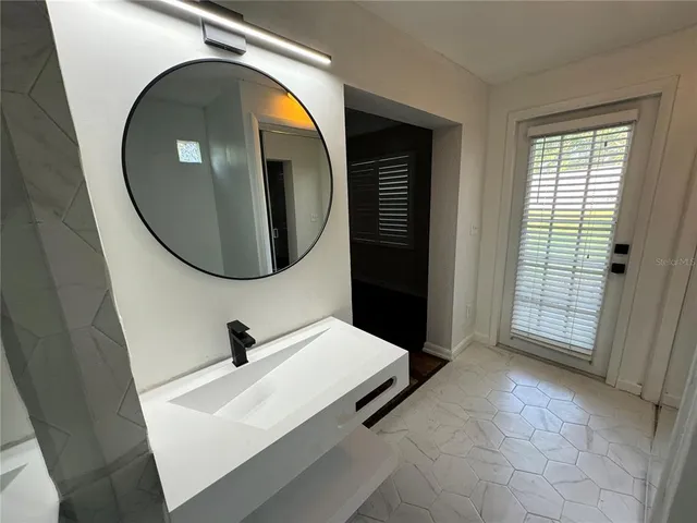 a bathroom with a sink and a mirror