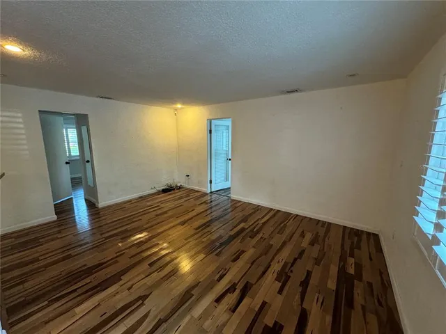 a view of a room with wooden floor