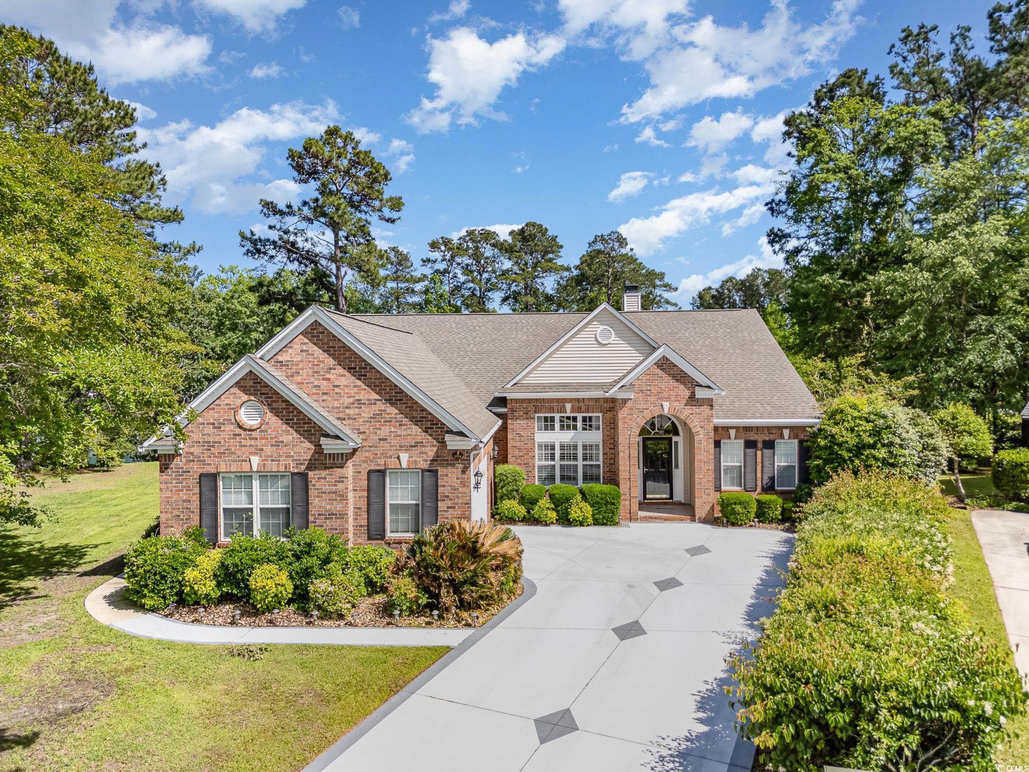1004 Addington Court Murrells Inlet, SC 29576 - Photo 1 of 40 View of front facade featuring driveway, brick siding, a chimney, and a shingled roof