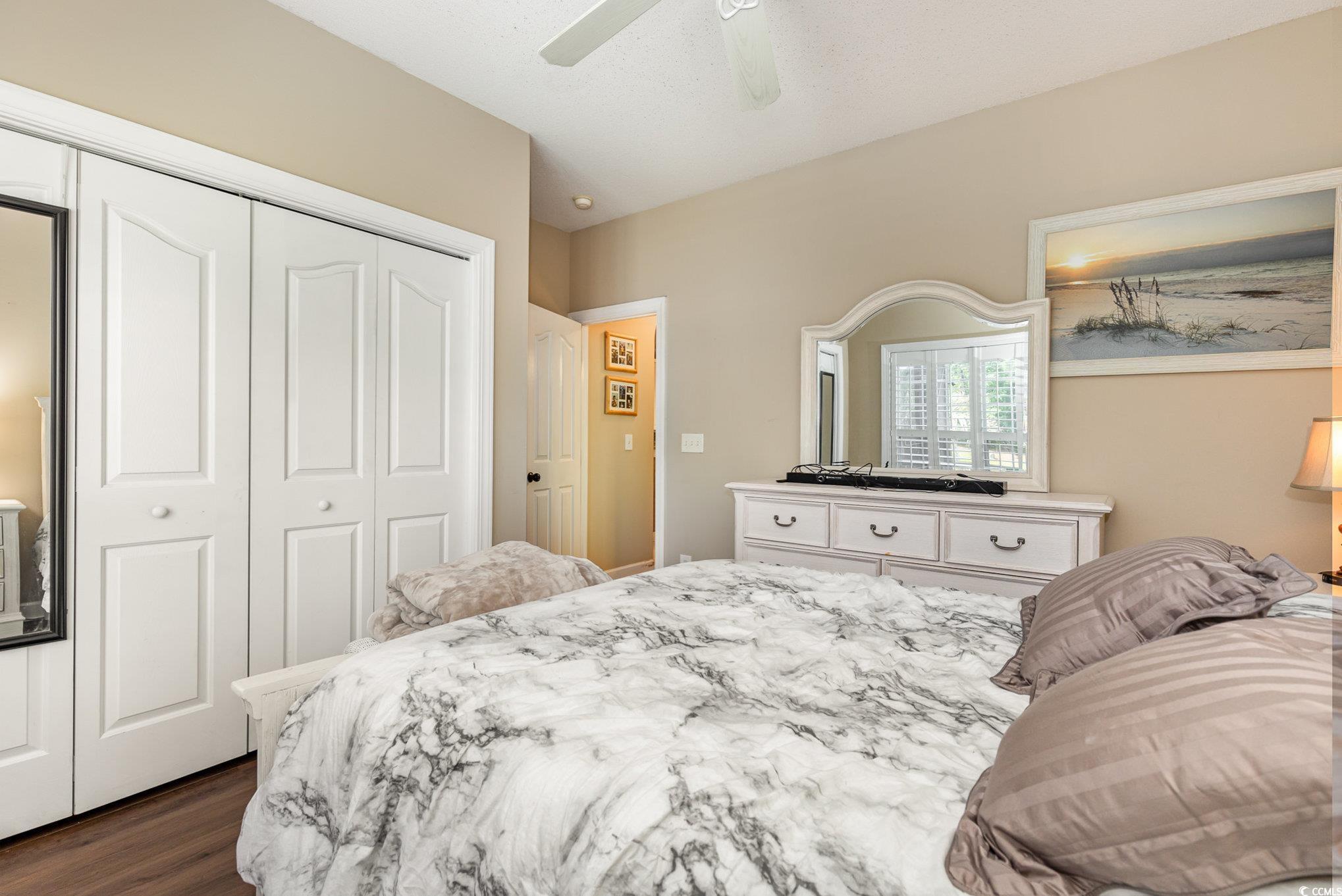 1004 Addington Court Murrells Inlet, SC 29576 - Photo 26 of 40 Bedroom with a closet, dark wood-type flooring, and a ceiling fan