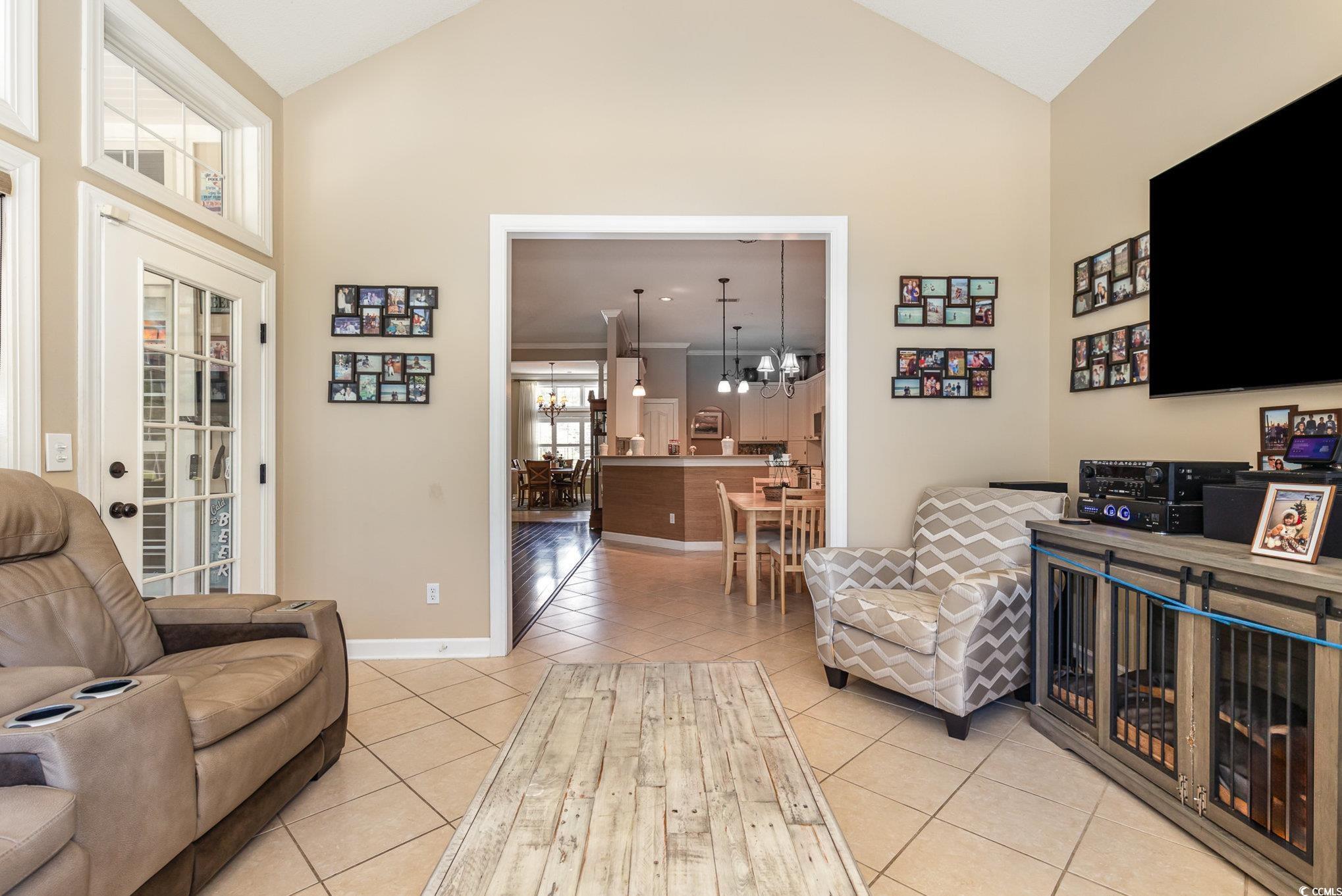 1004 Addington Court Murrells Inlet, SC 29576 - Photo 9 of 40 Living area featuring high vaulted ceiling, light tile patterned floors, and a chandelier