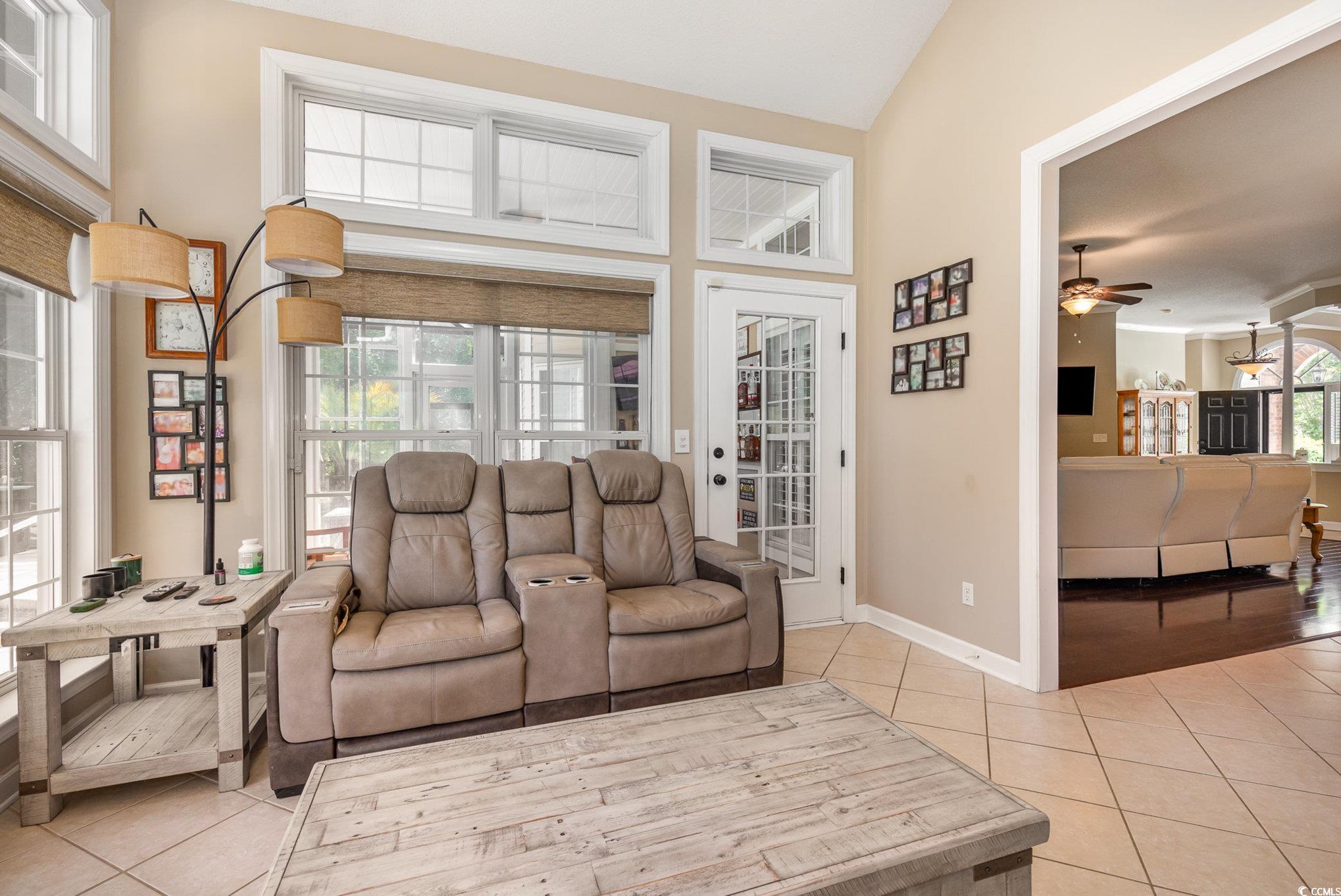 1004 Addington Court Murrells Inlet, SC 29576 - Photo 10 of 40 Living area with light tile patterned floors, a ceiling fan, and high vaulted ceiling