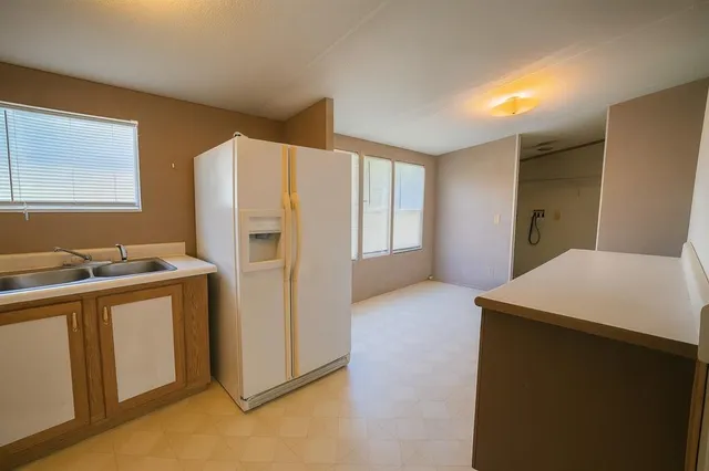 a kitchen with a refrigerator and a sink