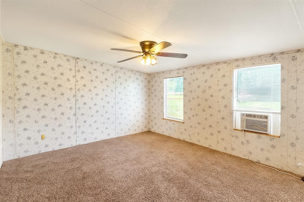 398 Avenue D Point, TX 75472 - Photo 6 of 11 a view of a livingroom with a chandelier fan and a window