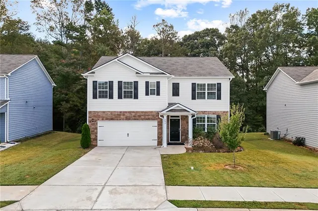 a front view of a house with a yard