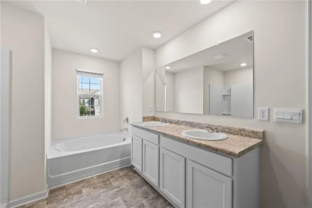 a bathroom with a tub shower and a sink