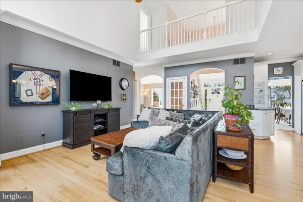 a kitchen with stainless steel appliances a stove a sink refrigerator and a refrigerator with wooden floor