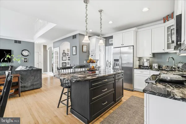 a kitchen with stainless steel appliances granite countertop a sink stove and microwave