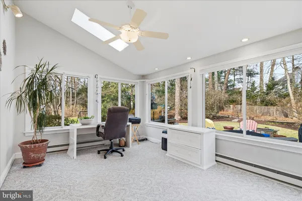 a view of livingroom with workspace and a window