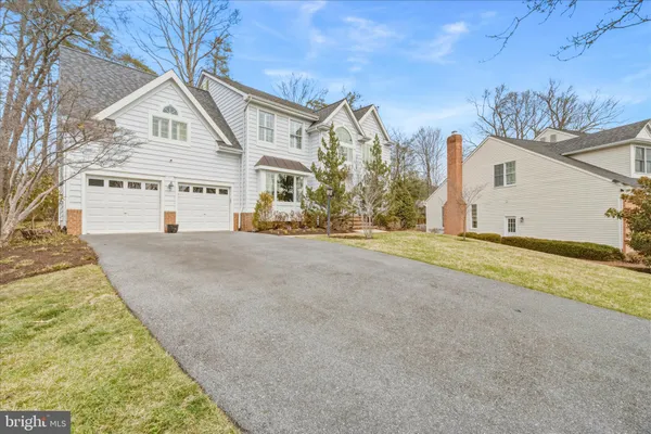 a view of a house with a yard and garage