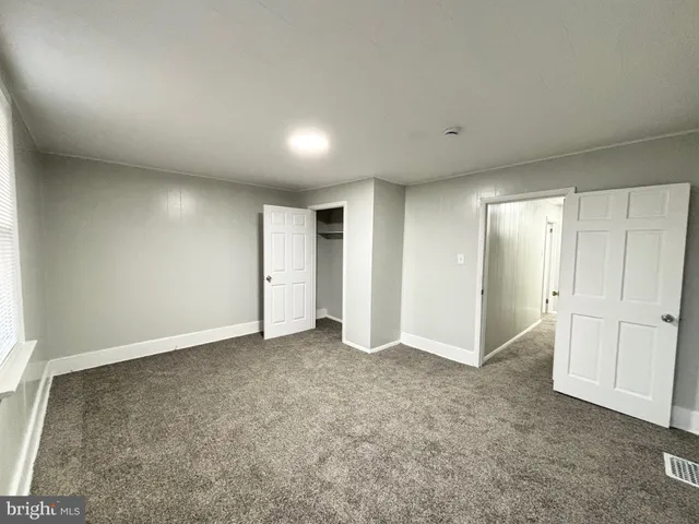 an empty room with closet area