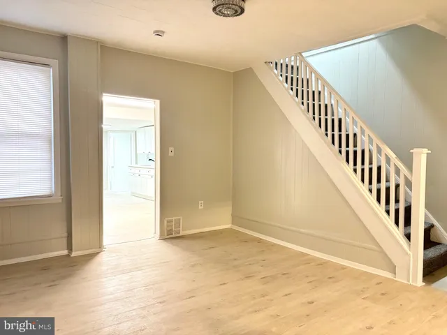 a view of an entryway with wooden floor