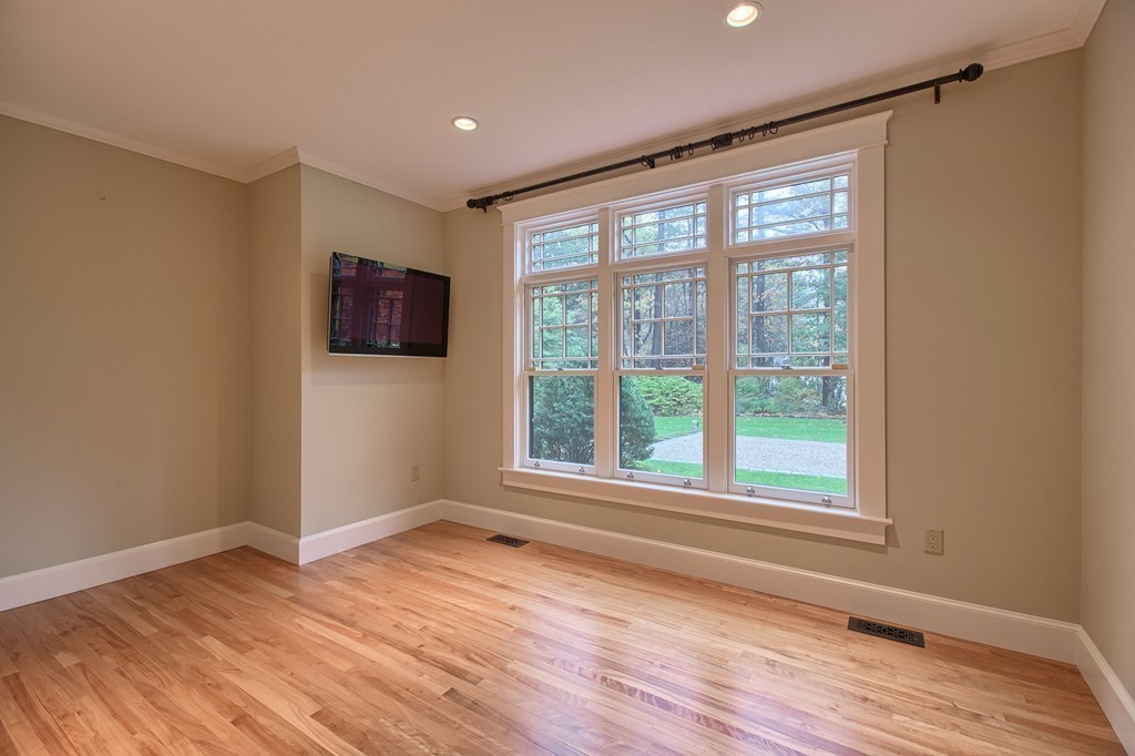 21 Valley Road Boxford, MA 01921 - Photo 14 of 28 a view of an empty room with wooden floor and a window