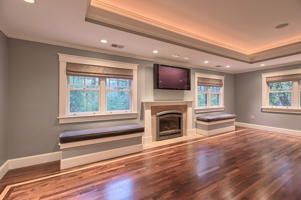 21 Valley Road Boxford, MA 01921 - Photo 19 of 28 a living room with a fireplace furniture a flat screen tv and wooden floor