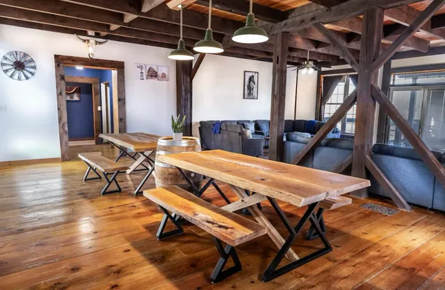 a kitchen with granite countertop a table chairs stove refrigerator and cabinets