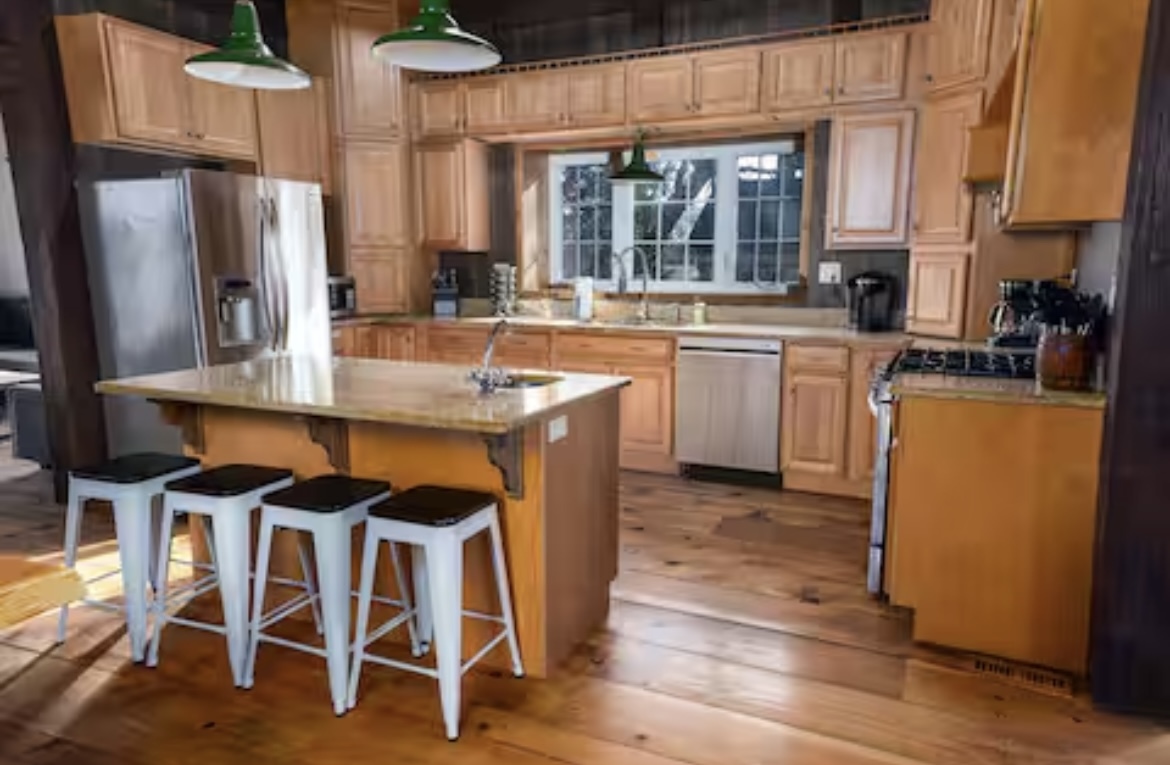 9439 Corneils Road Bristol, IL 60512 - Photo 12 of 44 a kitchen with granite countertop a table chairs stove refrigerator and cabinets