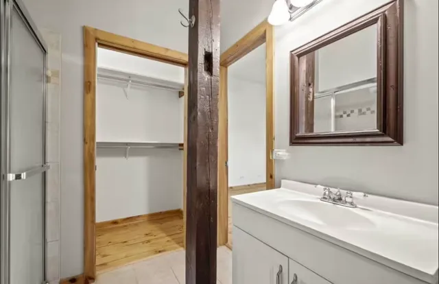 a bathroom with a sink a toilet and a shower