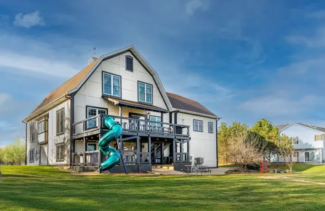 a front view of a house with a yard table and chairs