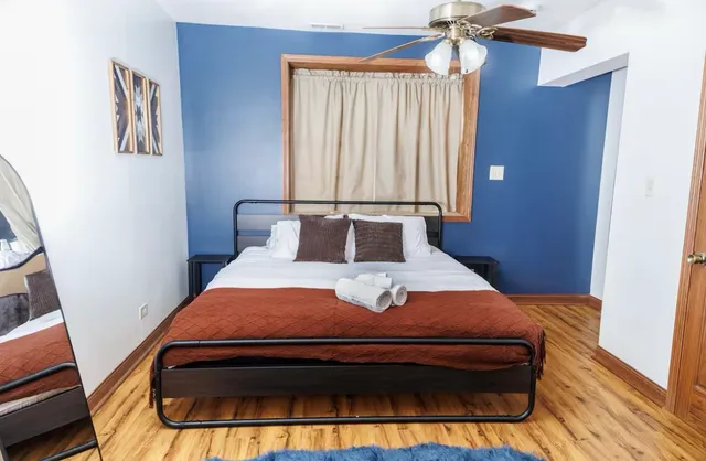 a bed sitting in a bedroom next to a window