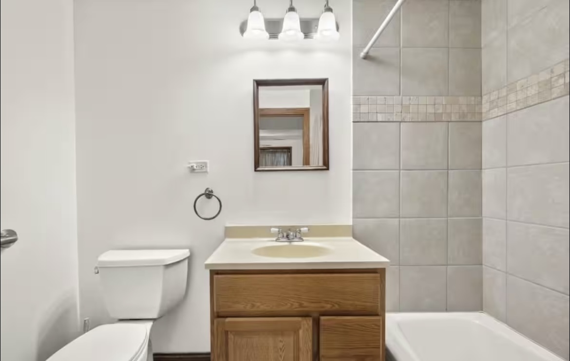 9439 Corneils Road Bristol, IL 60512 - Photo 36 of 44 a bathroom with a toilet sink and mirror