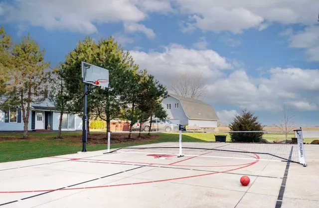 a view of a livingroom with wooden floor and a ceiling fan