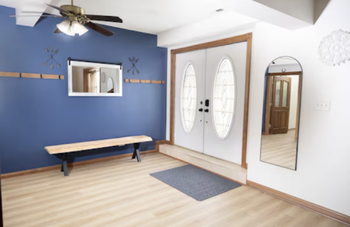 9439 Corneils Road Bristol, IL 60512 - Photo 6 of 44 a view of a livingroom with wooden floor and a ceiling fan