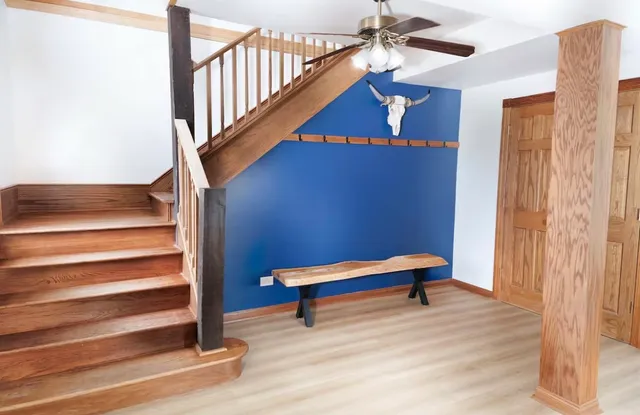 a view of entryway and hall with wooden floor