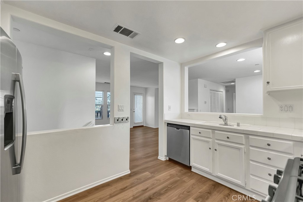 40 Three Vines Court Ladera Ranch, CA 92694 - Photo 15 of 28 a large kitchen with a lot of counter space and wooden floor