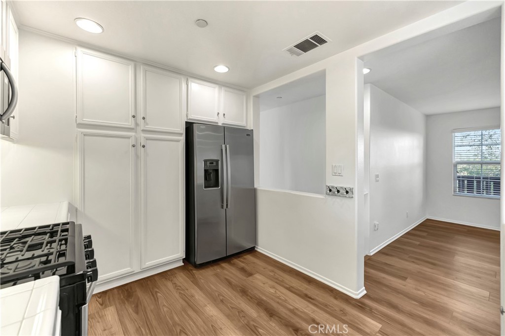 40 Three Vines Court Ladera Ranch, CA 92694 - Photo 16 of 28 a view of an empty room with wooden floor and a window