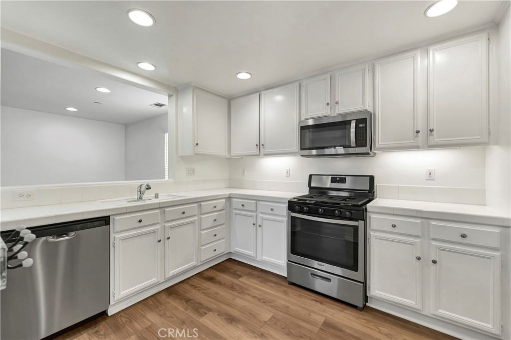 40 Three Vines Court Ladera Ranch, CA 92694 - Photo 17 of 28 a kitchen with a sink stove and microwave