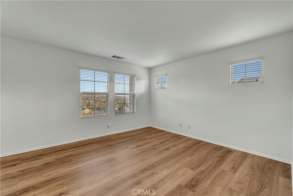 40 Three Vines Court Ladera Ranch, CA 92694 - Photo 19 of 28 an empty room with wooden floor and windows