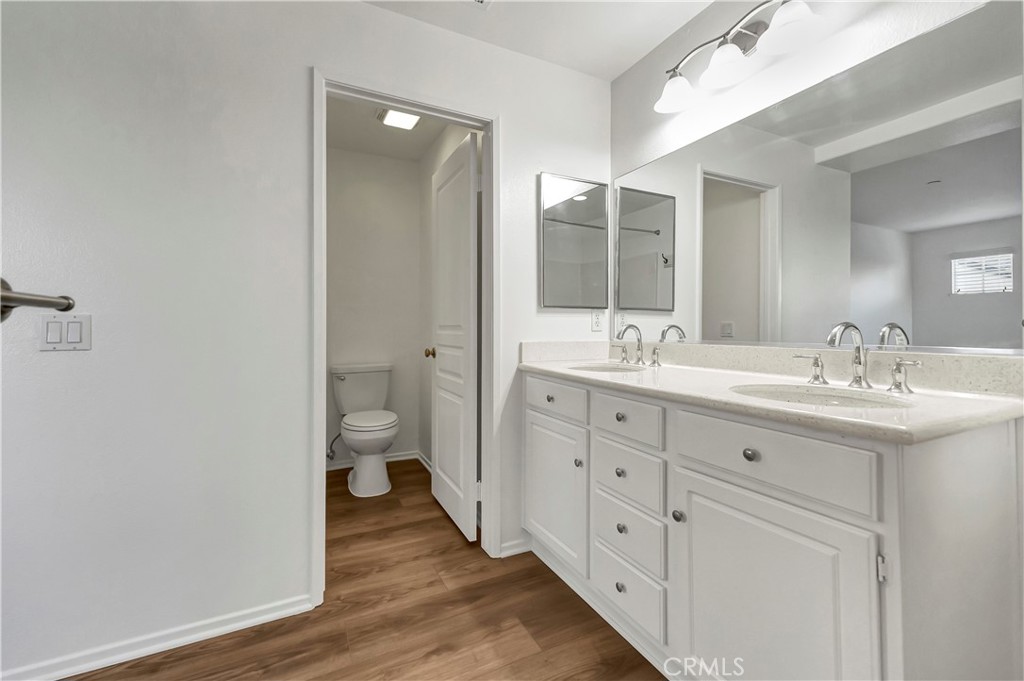 40 Three Vines Court Ladera Ranch, CA 92694 - Photo 23 of 28 a spacious bathroom with a double vanity sink toilet and a mirror