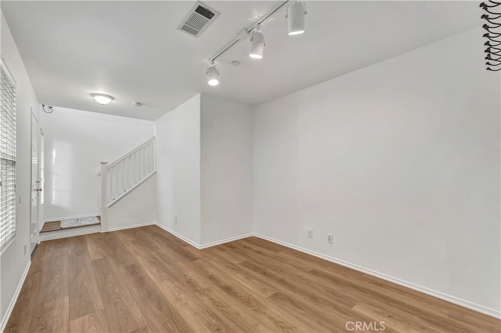 40 Three Vines Court Ladera Ranch, CA 92694 - Photo 24 of 28 an empty room with wooden floor and windows
