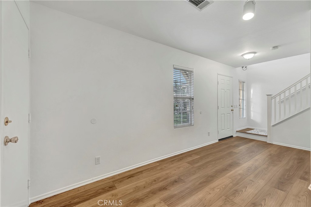 40 Three Vines Court Ladera Ranch, CA 92694 - Photo 25 of 28 a view of an empty room with wooden floor