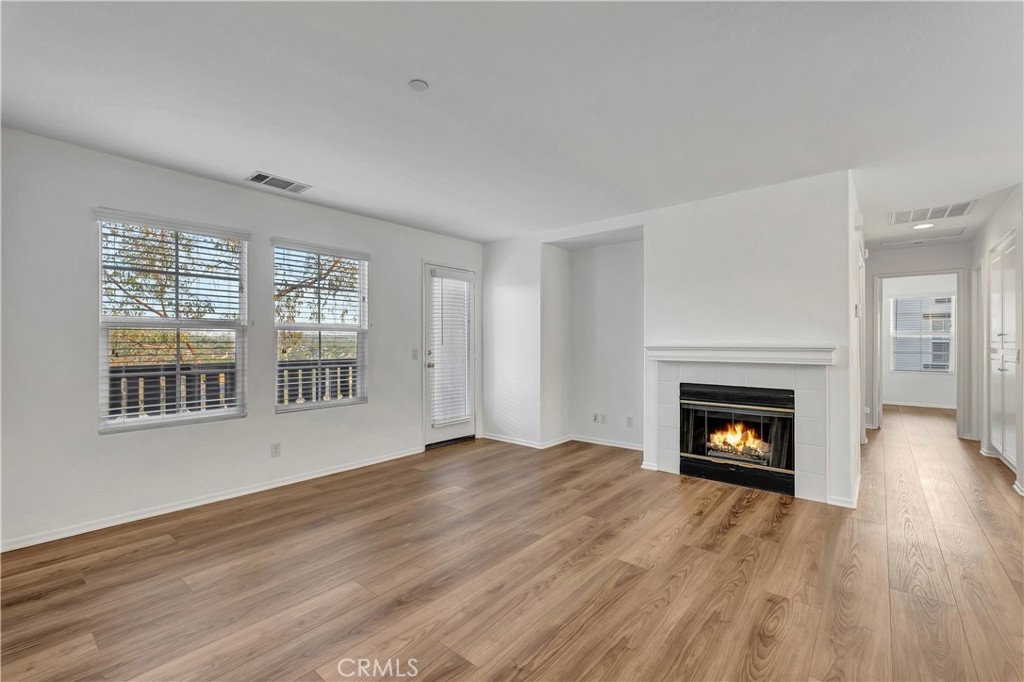 40 Three Vines Court Ladera Ranch, CA 92694 - Photo 3 of 28 a view of an empty room with wooden floor fireplace and a window