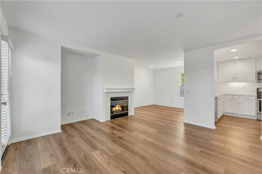 40 Three Vines Court Ladera Ranch, CA 92694 - Photo 4 of 28 a view of empty room with wooden floor and fireplace