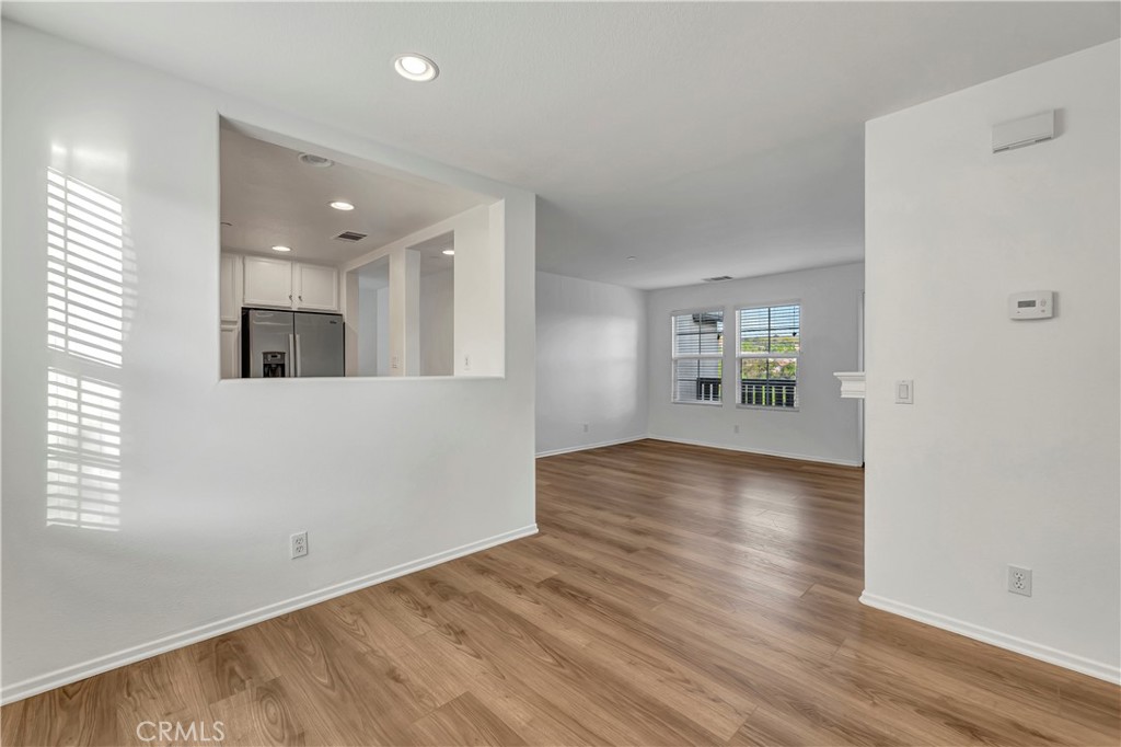 40 Three Vines Court Ladera Ranch, CA 92694 - Photo 8 of 28 an empty room with wooden floor and windows