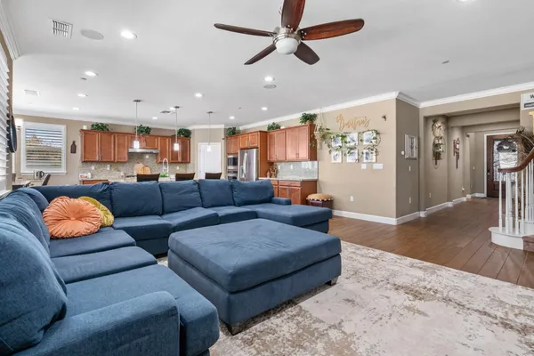 a living room with furniture and a wooden floor
