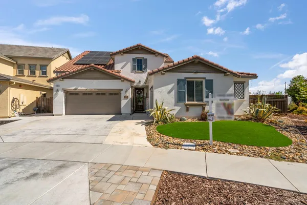 a front view of a house with a yard and garage