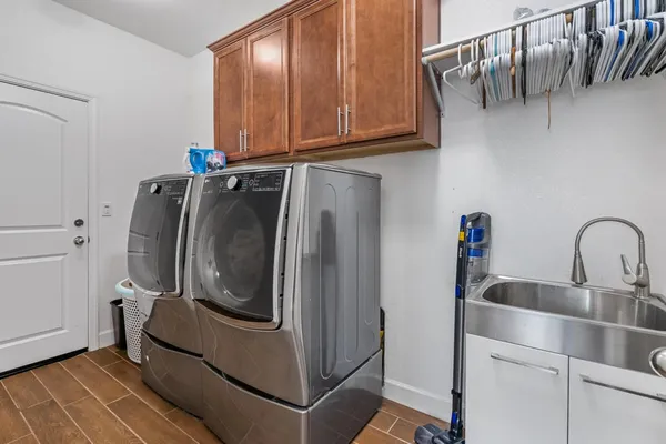 a bed sitting in a spacious bedroom next to a window