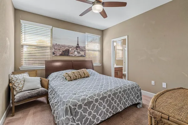 a bed sitting in a bedroom next to a window