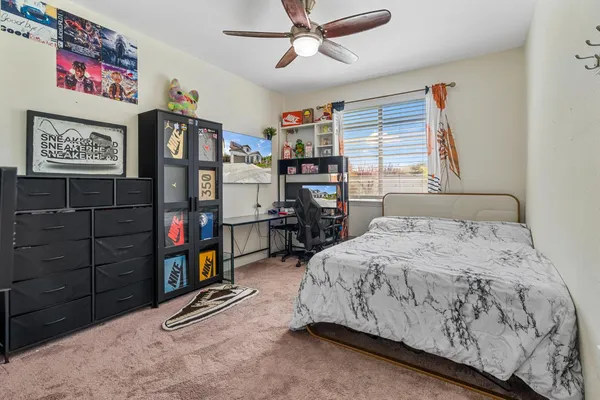 a open kitchen with kitchen island a stove a sink a oven a dining table and chairs with wooden floor