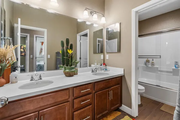 a view of kitchen with stainless steel appliances granite countertop a stove and a refrigerator