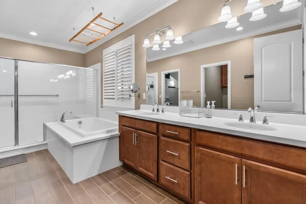 a front view of a house with a yard and potted plants