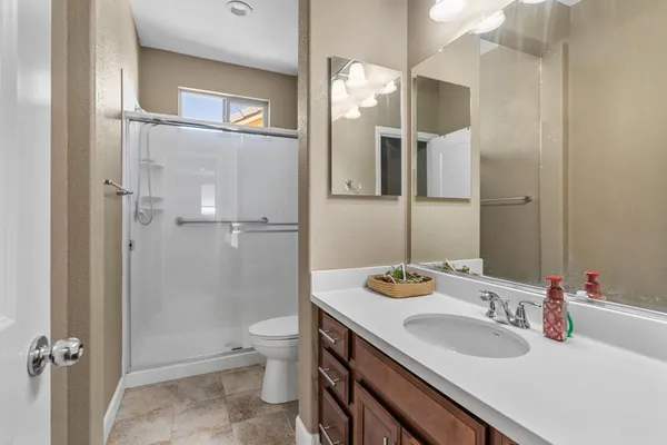 an aerial view of a city with lots of residential buildings ocean and mountain view in back