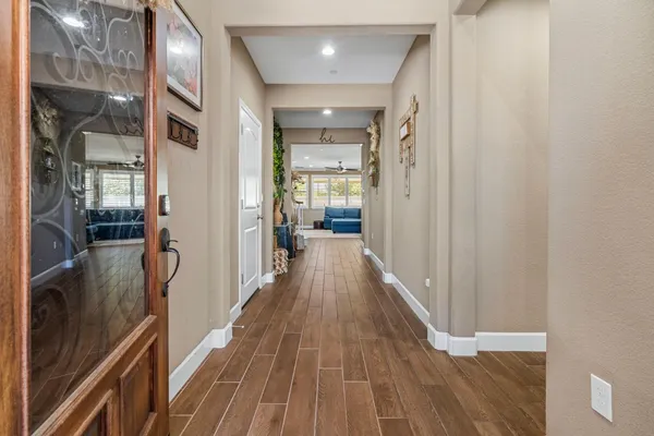 a view of a hallway with wooden floor and staircase
