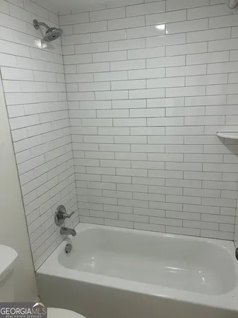 a bathroom with a bathtub and a toilet