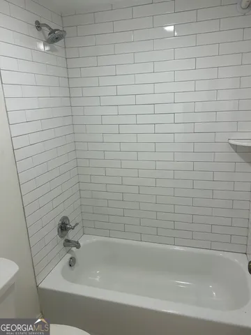 a bathroom with a bathtub and a toilet